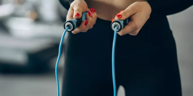 Woman using jumping rope gym
