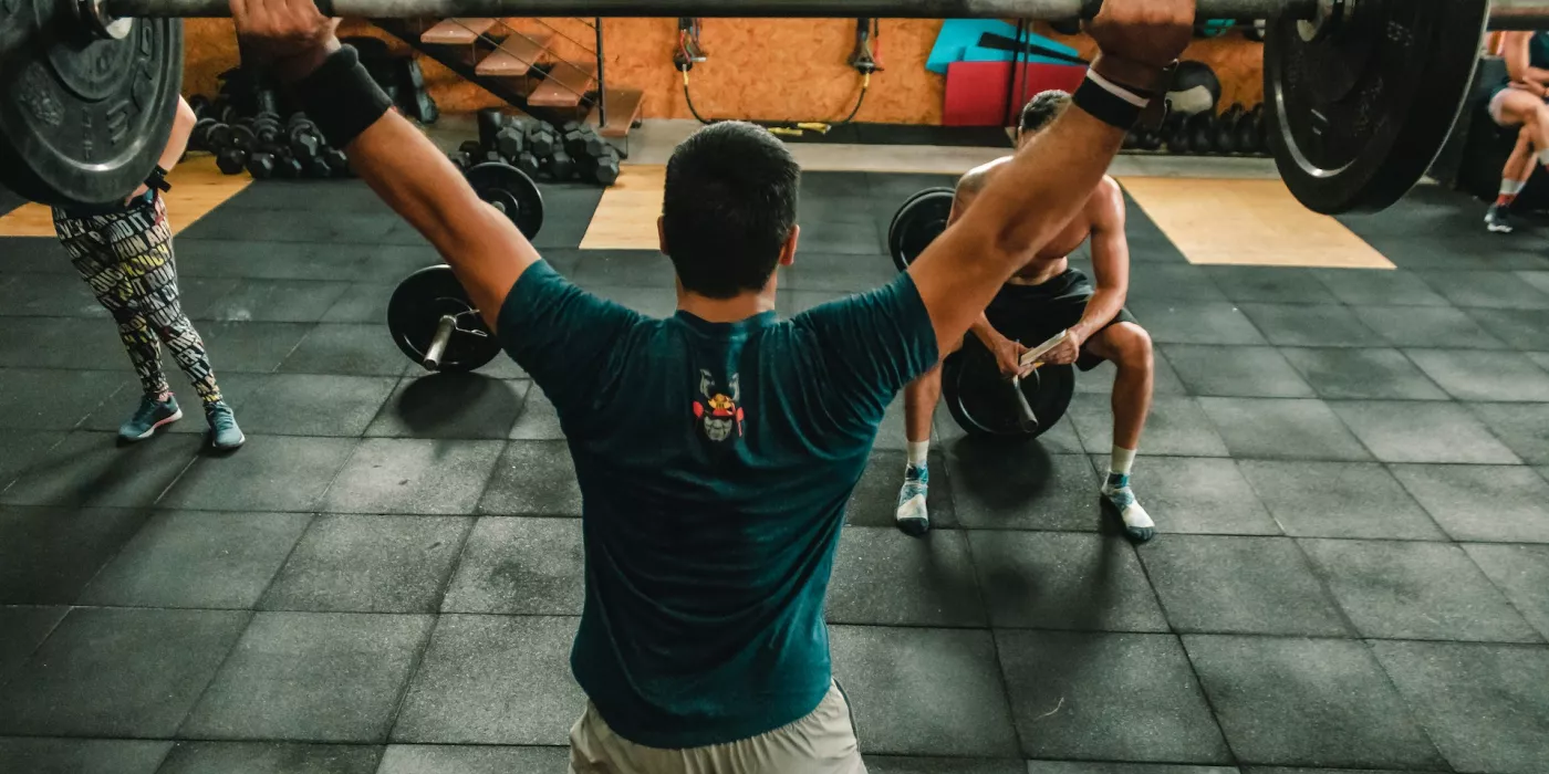 Person Lifting Barbell Indoors