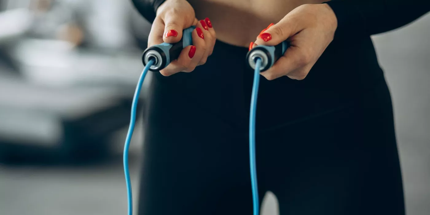 Woman using jumping rope gym